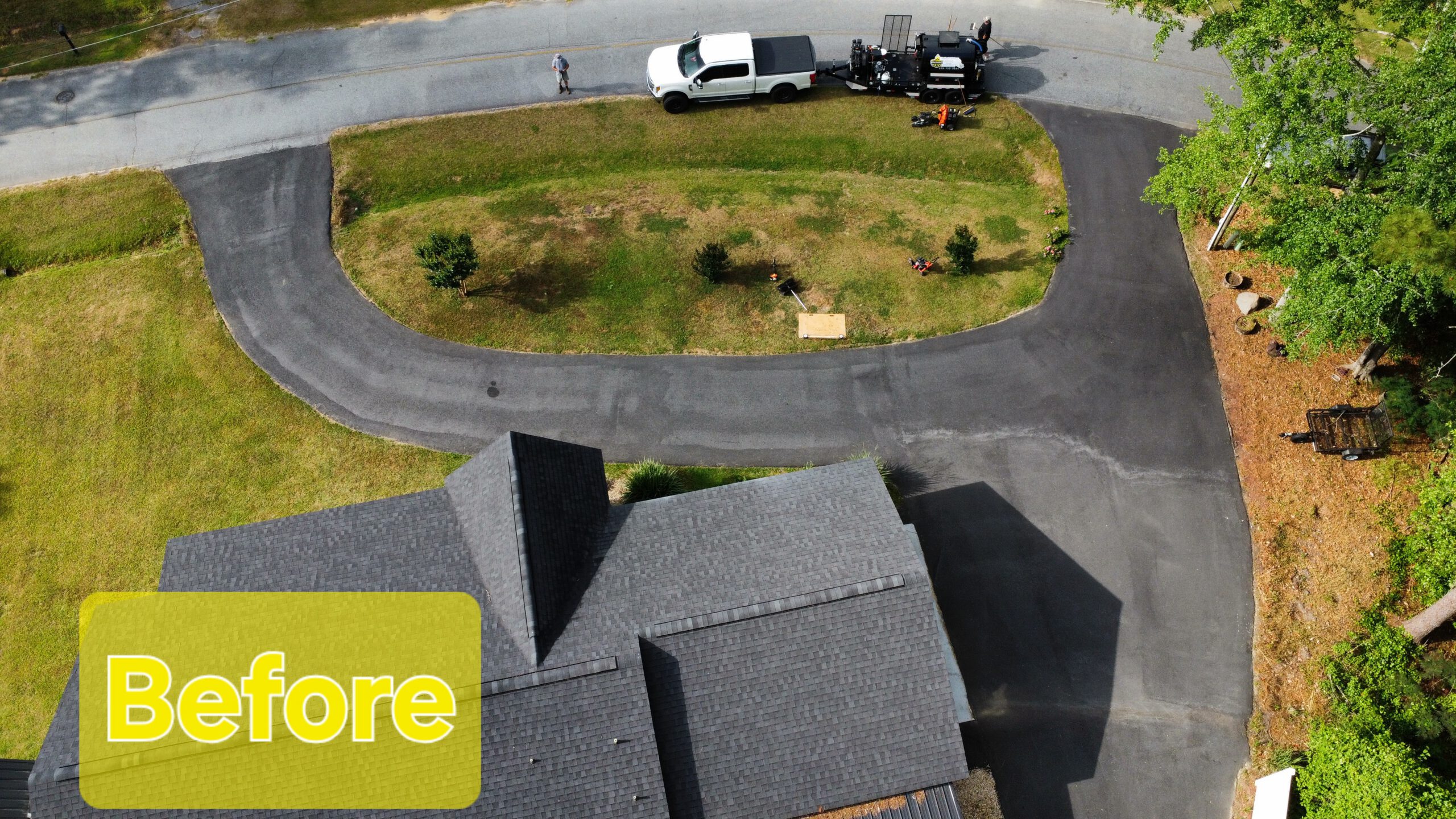 Worn grey faded residential driveway before sealcoating