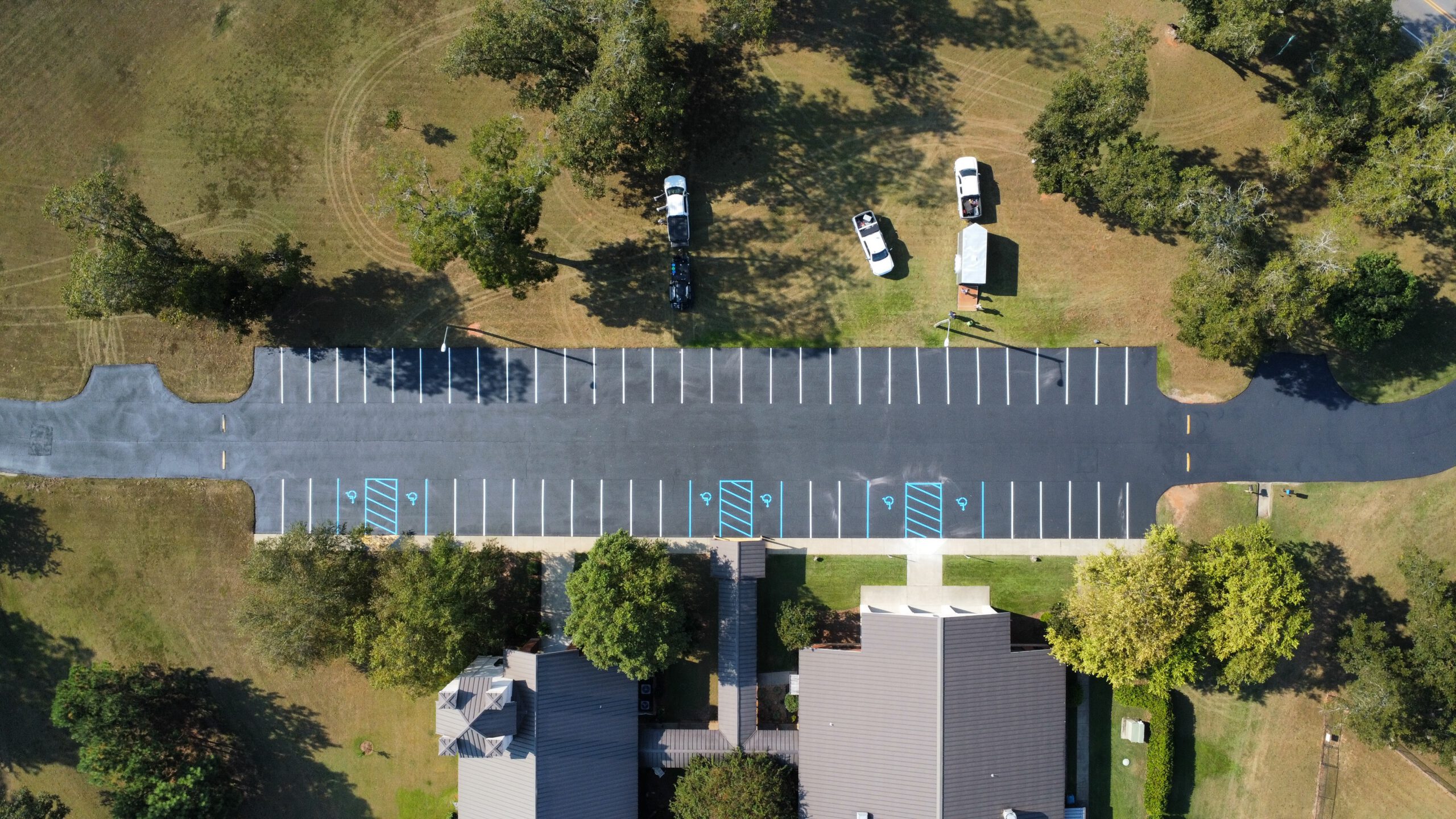 Long commercial parking lot with accessible spaces and fresh striping