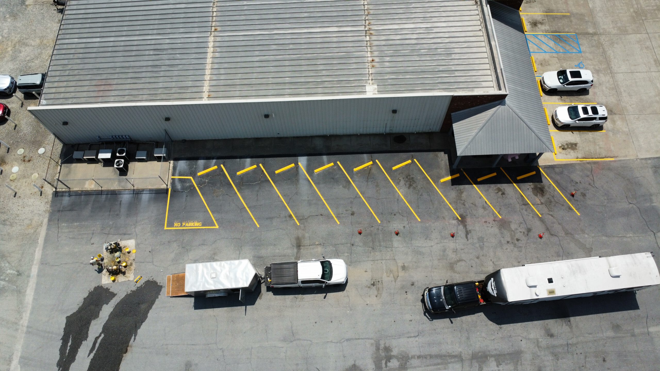 Aerial view of commercial lot with fresh striping and NO PARKING markings