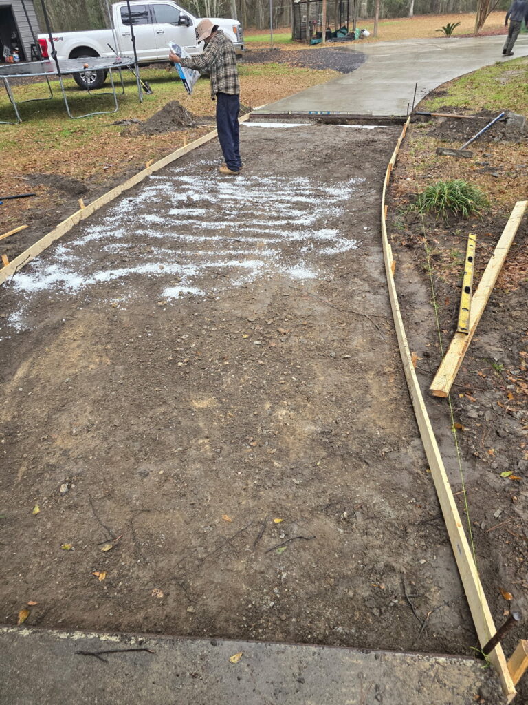 Driveway subgrade graded with wood forms set and ready for a concrete pour