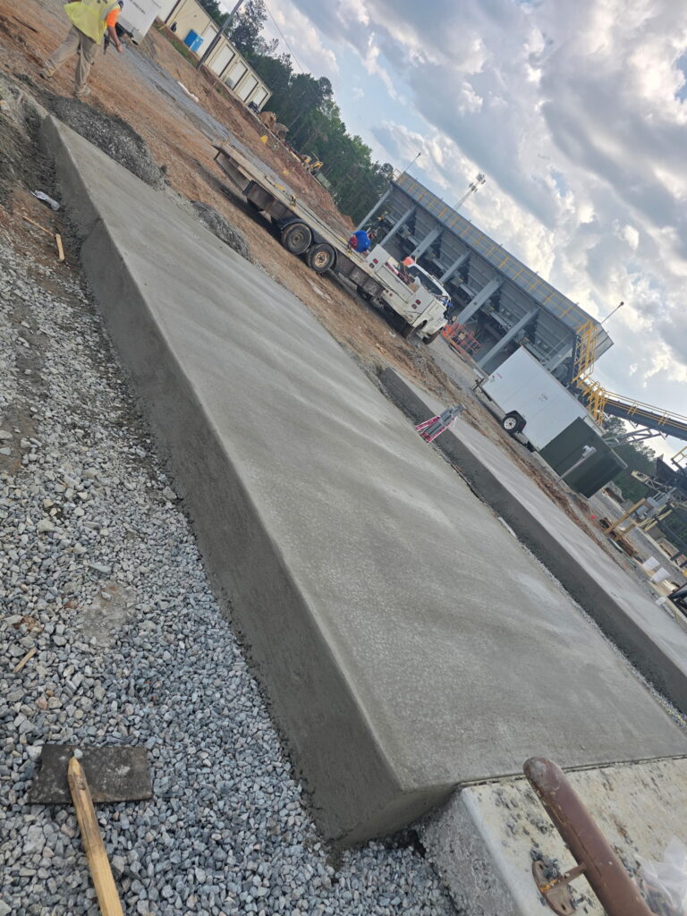 Finished commercial concrete slab with a thickened edge on a stone base