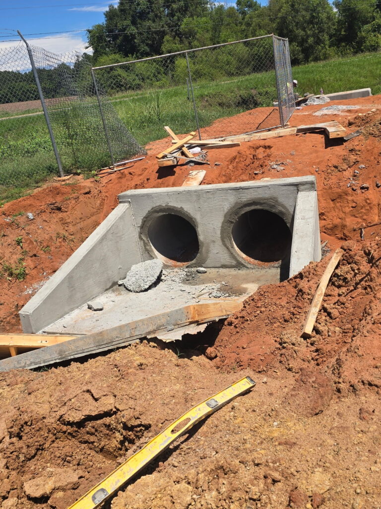 Concrete headwall built on a double pipe culvert crossing